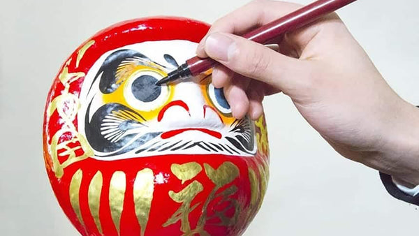 What is the history behind Daruma and how to paint the eyes?